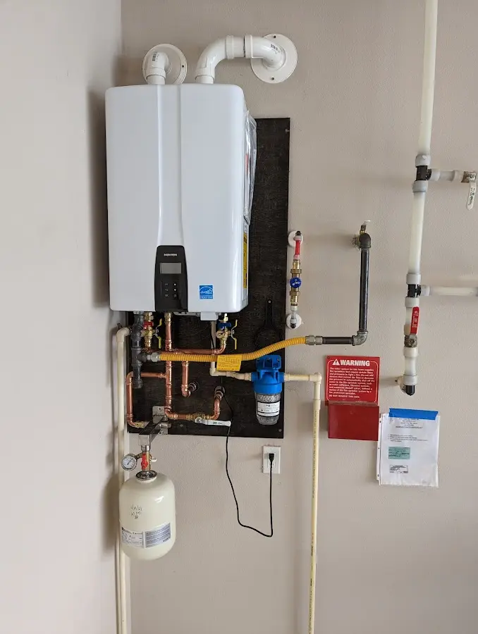 Professional plumber installing copper piping in a Kinston home